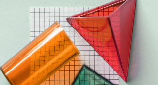 Imagen de  Three plastic shapes on top of drawing paper